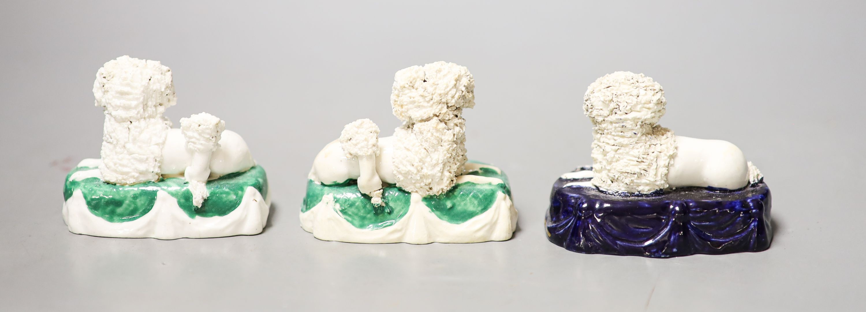 Three Staffordshire porcelain groups of a poodle and puppies, c.1830–50